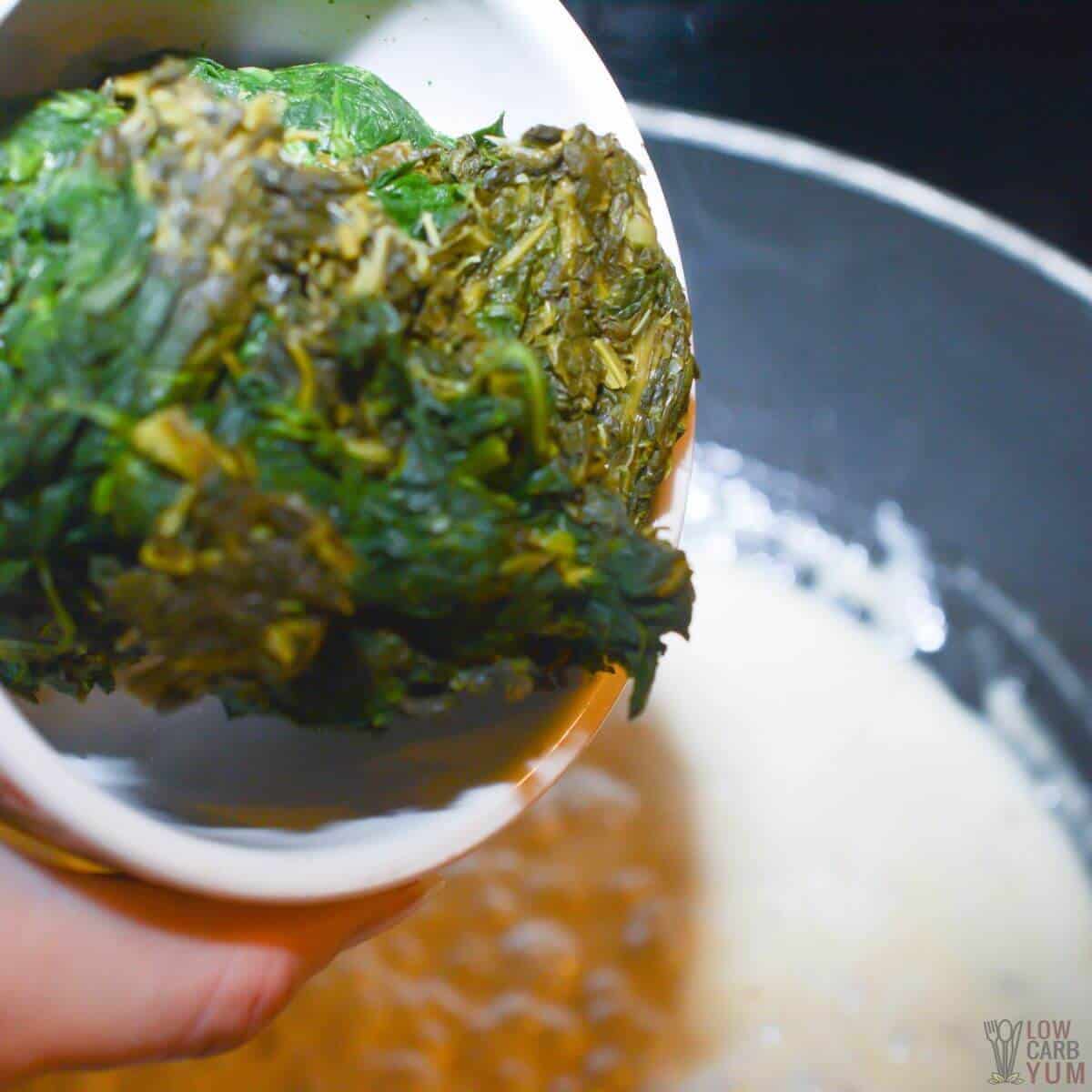 adding spinach to sauce.