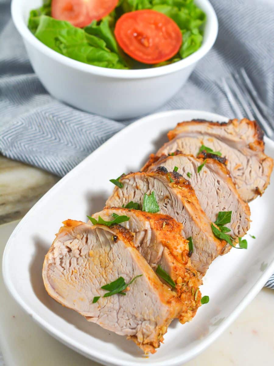 pork tenderloin on a white platter