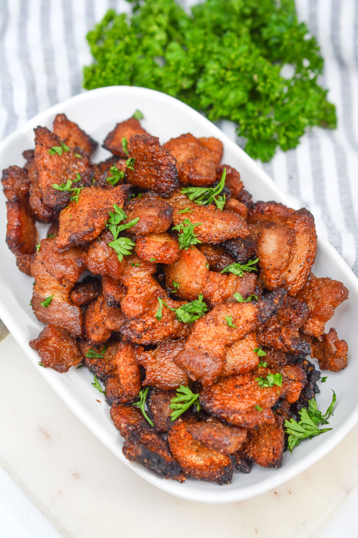 keto pork belly bites in a white bowl