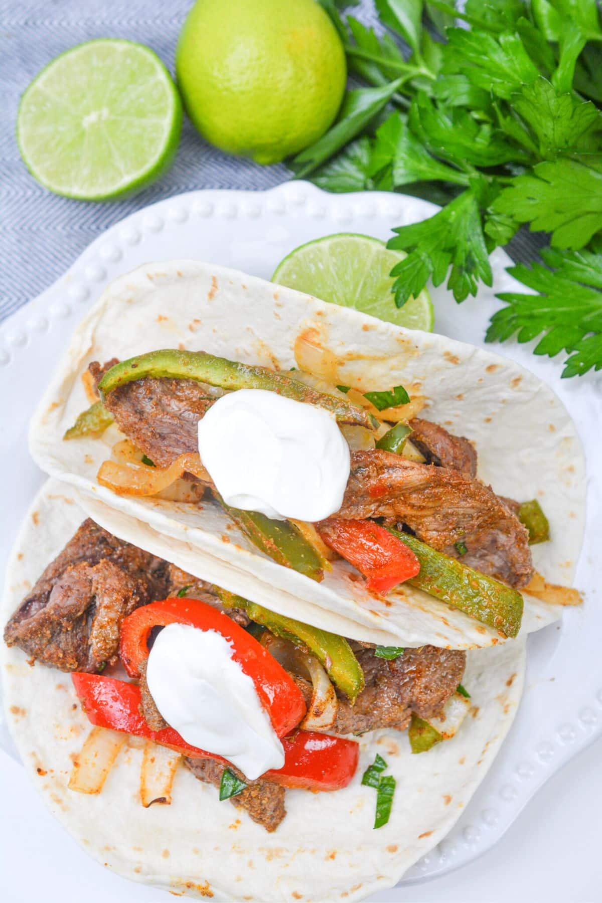 adding steak and veggies in fajita tacos