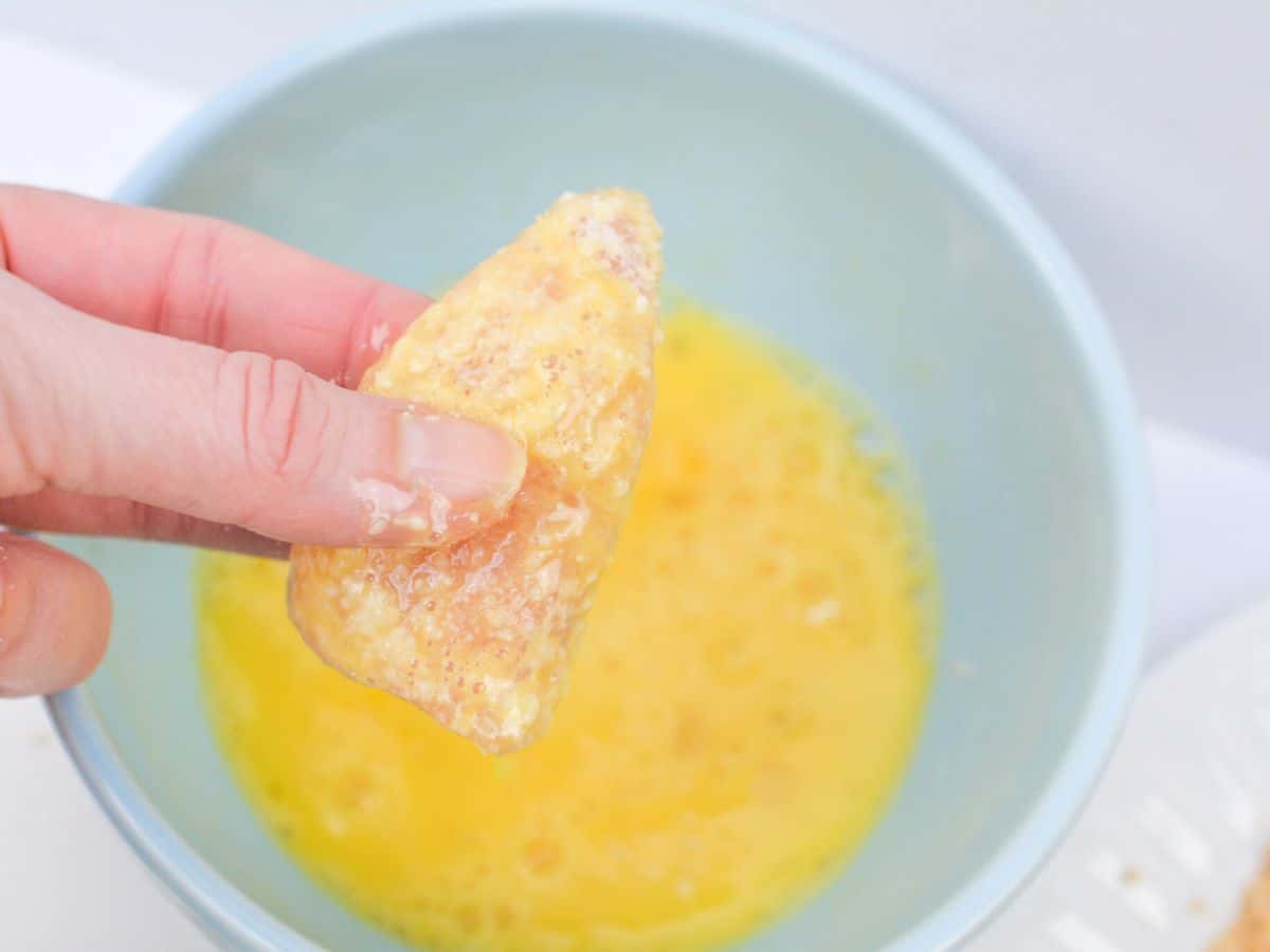 dunking chicken into egg wash