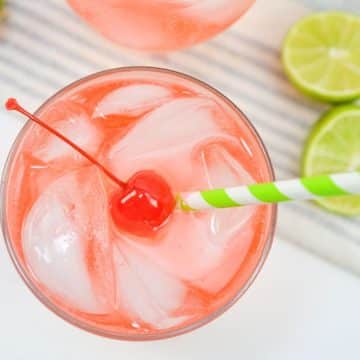 cherry limeade in a glass with cherry