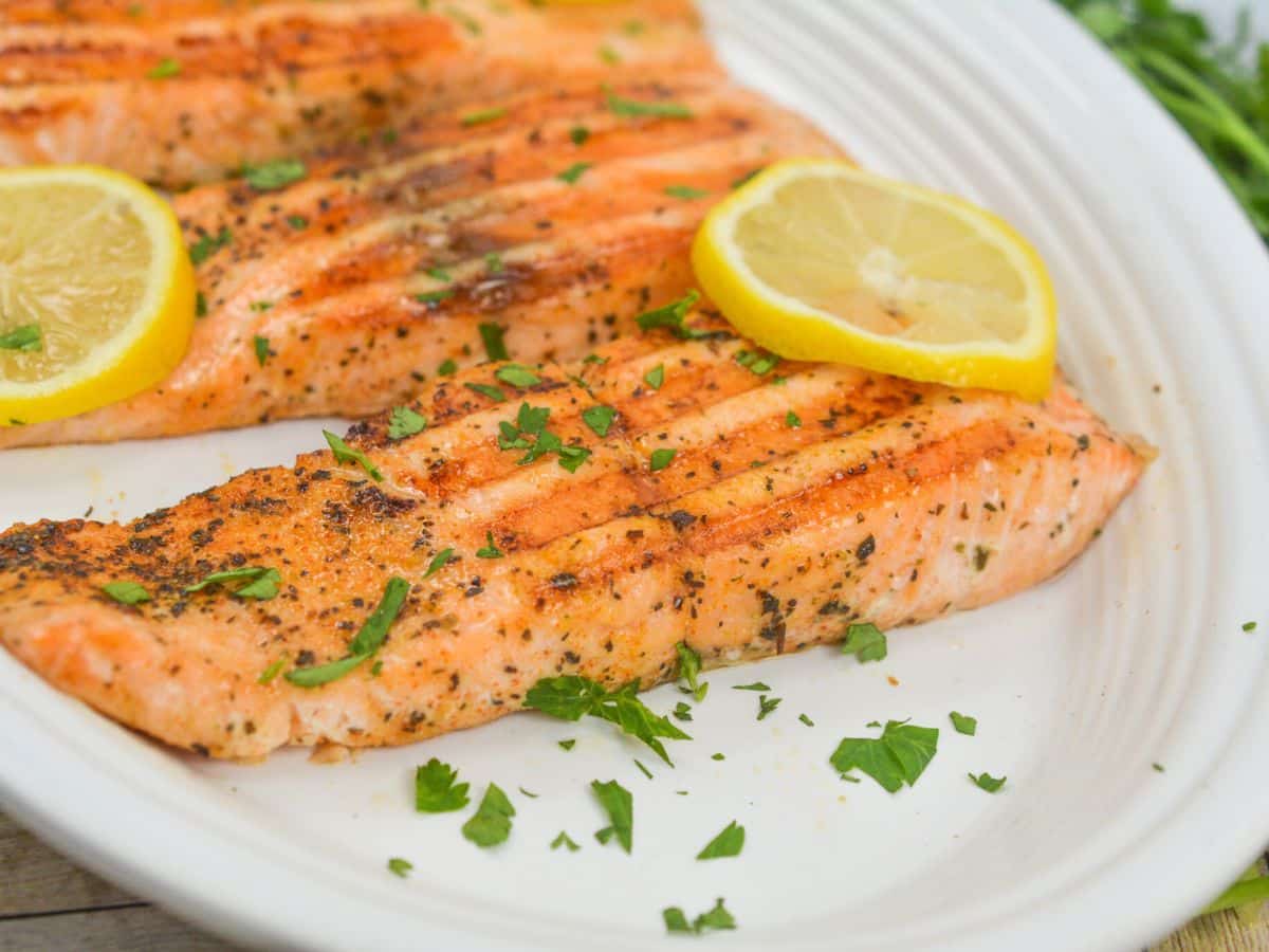 Grilled salmon on a white platter