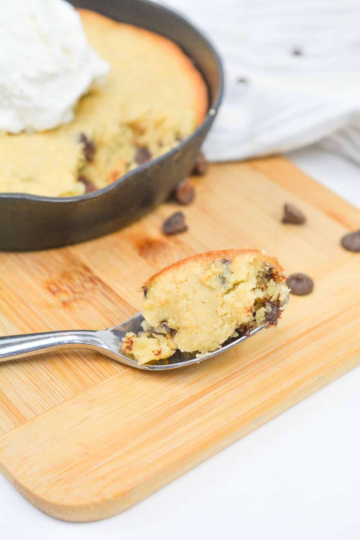 taking a bite of keto cookie skillet