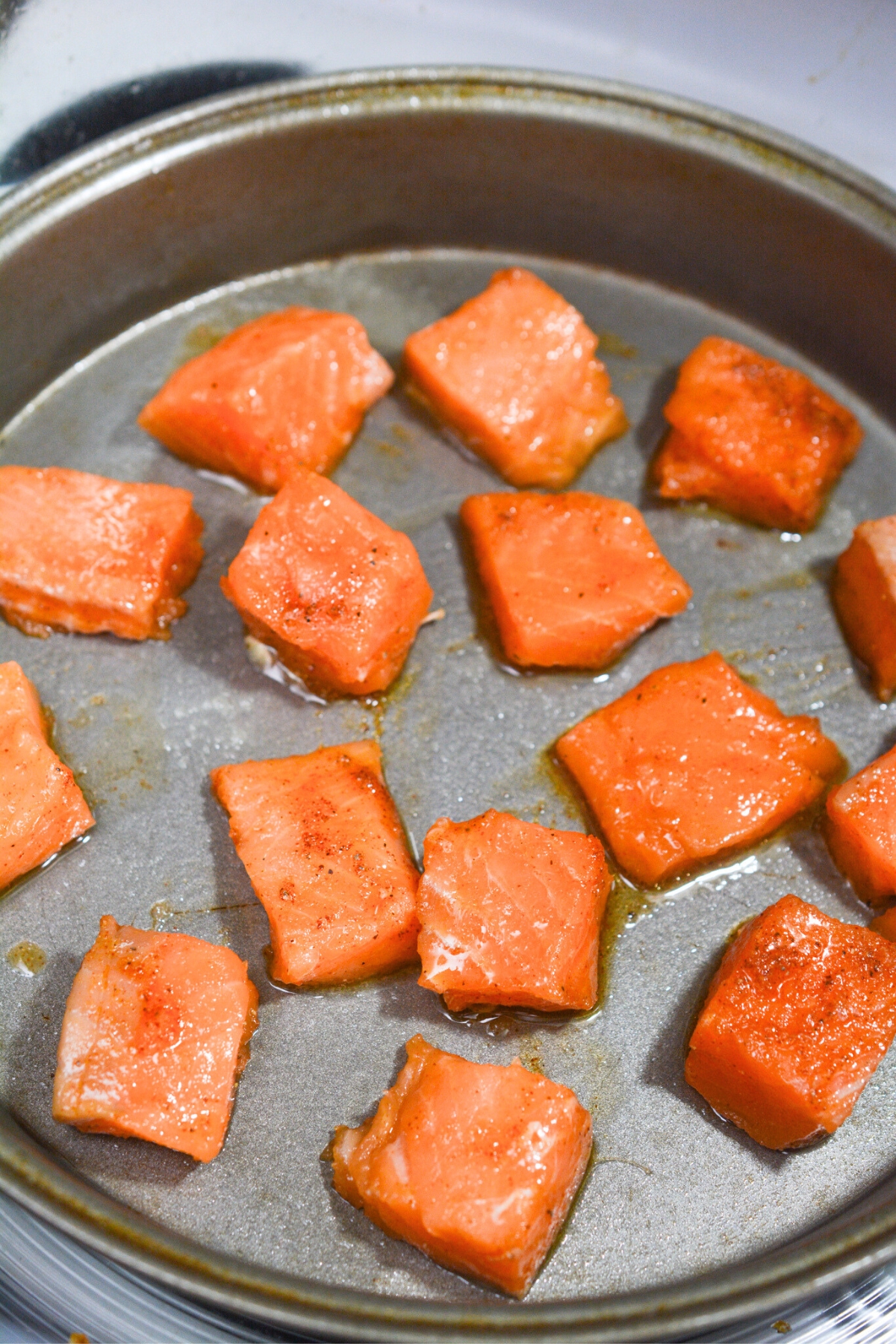 raw salmon in a air fryer pan