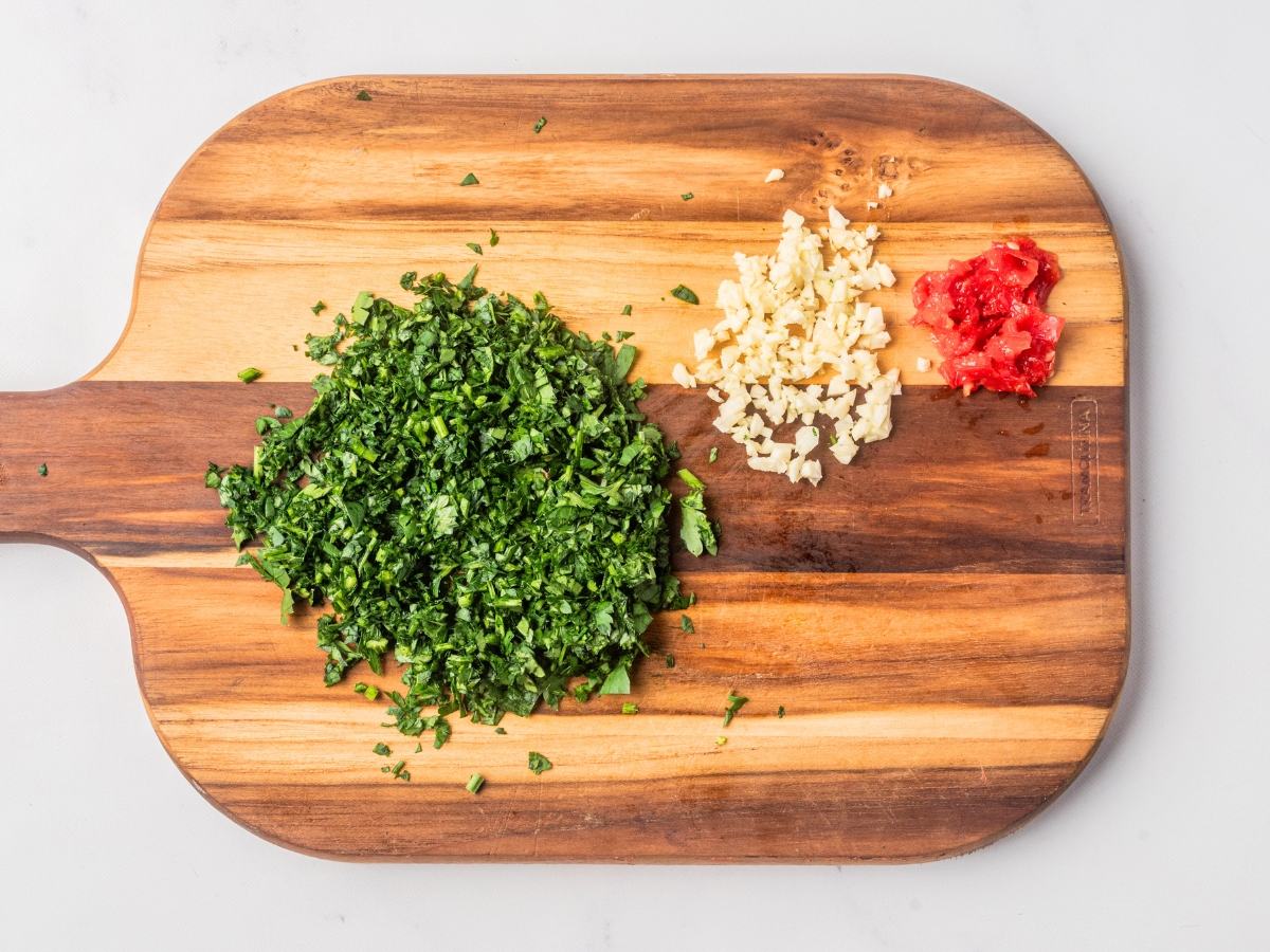 chopped veggies and peppers on a board