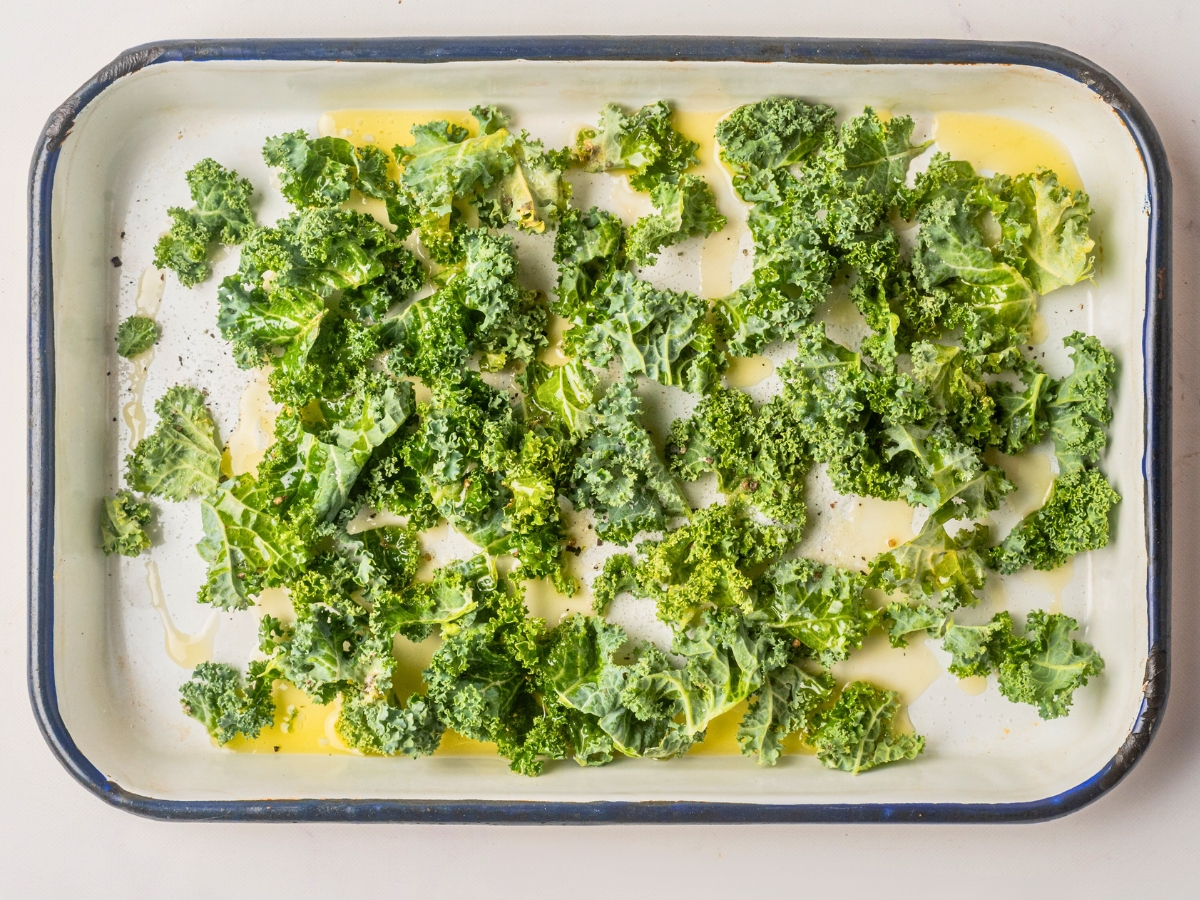 drizzling oil over kale