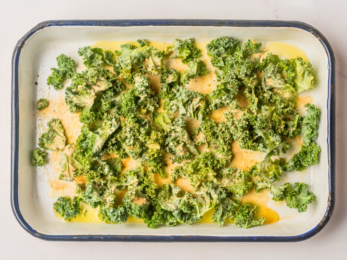 seasoning kale leaves on pan