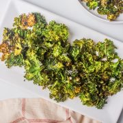crispy kale chips on a white platter