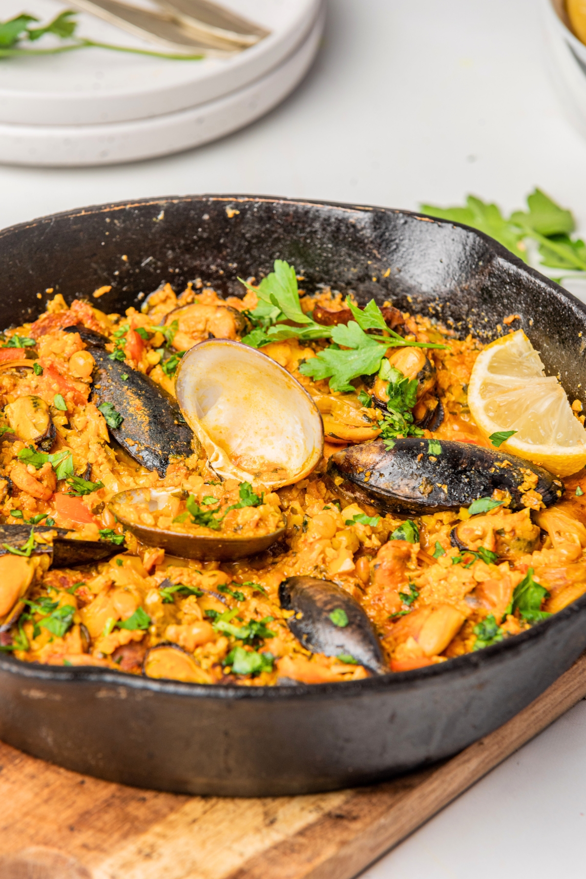 paella skillet with lemon wedges