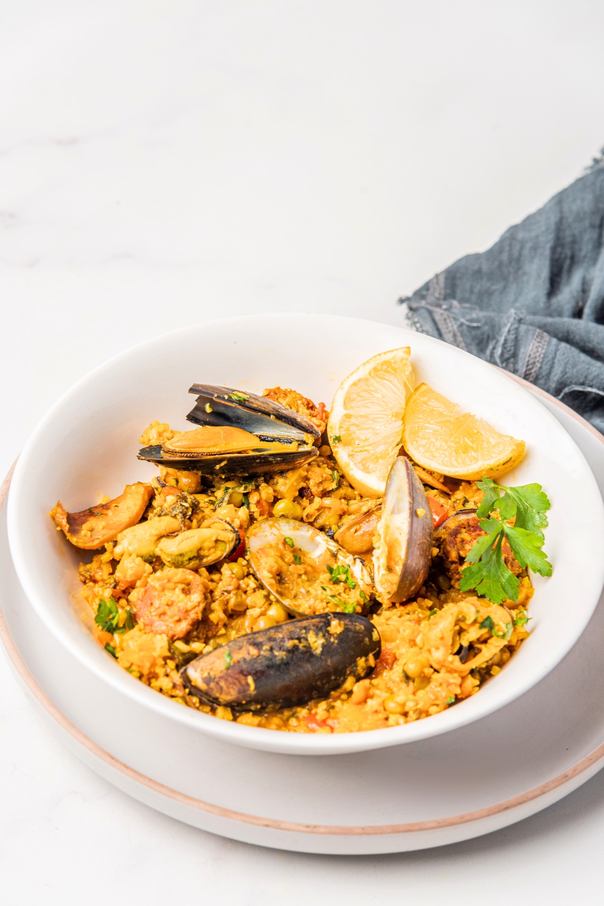 a bowl of paella with chorizo and seafood