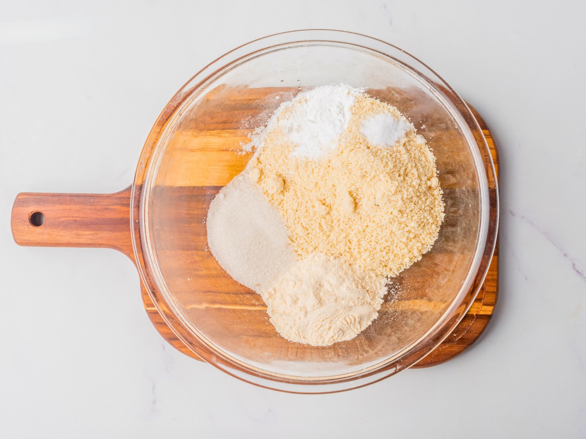 adding dry ingredients to a bowl