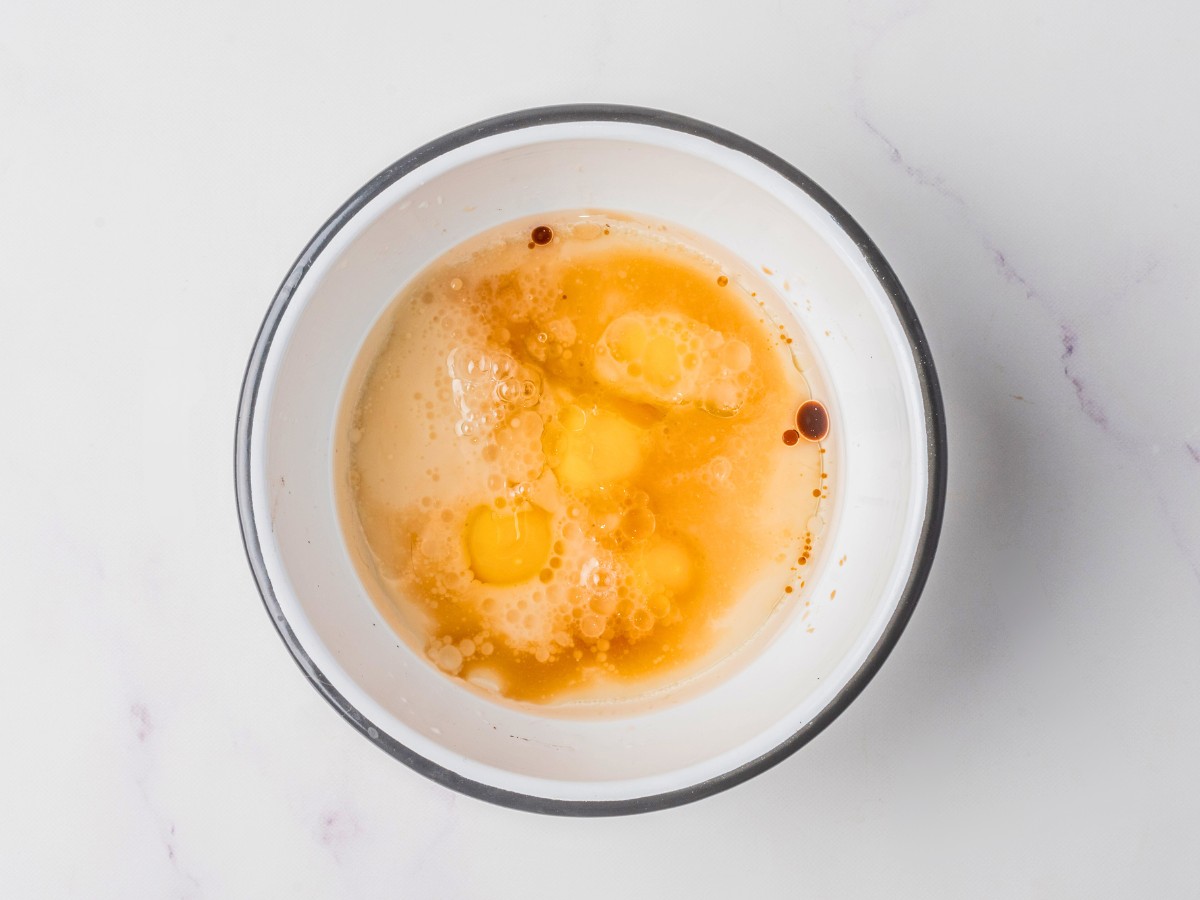 adding wet ingredients to a bowl