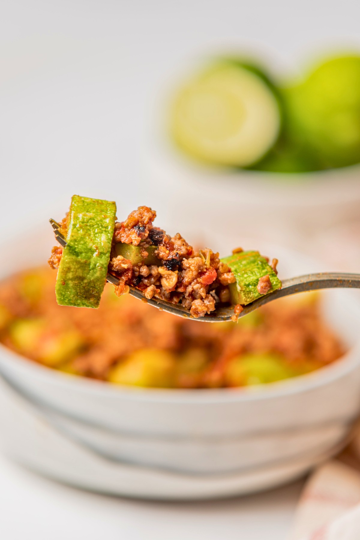 taking a bite of Mexican zucchini and ground beef dinner