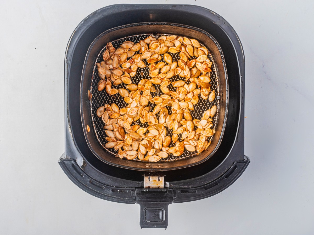 roasting pumpkin seeds in the air fryer basket. 