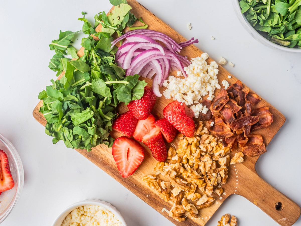 salad ingredients on a wooden board.