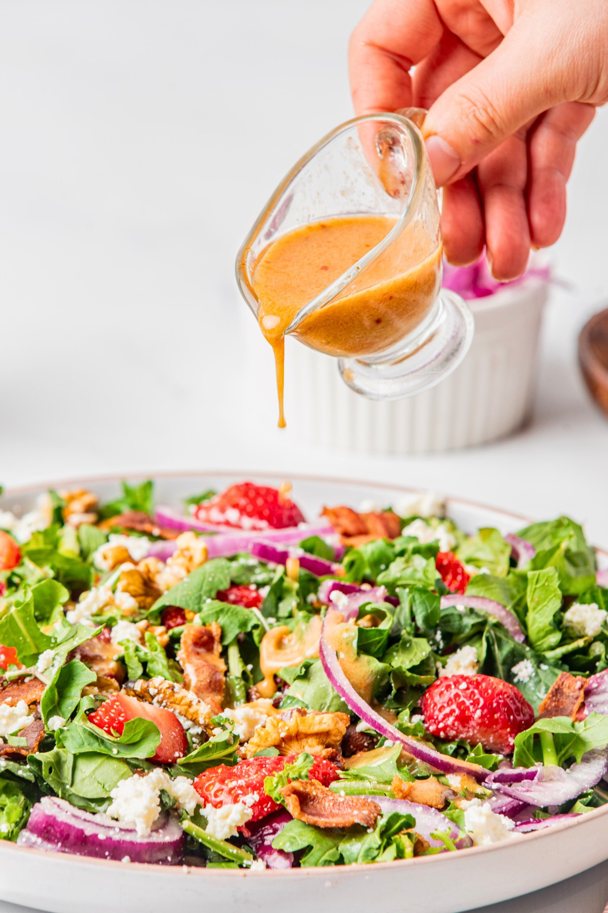 drizzling on vinaigrette on top of goat cheese walnut salad. 