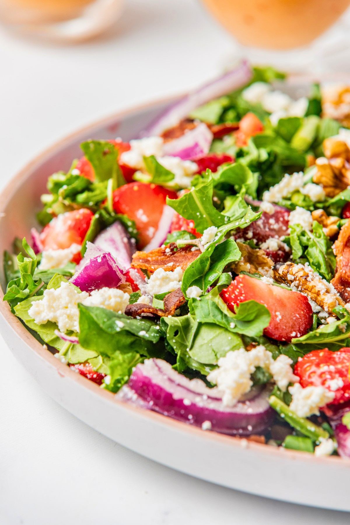 adding bacon to arugula walnut salad. 