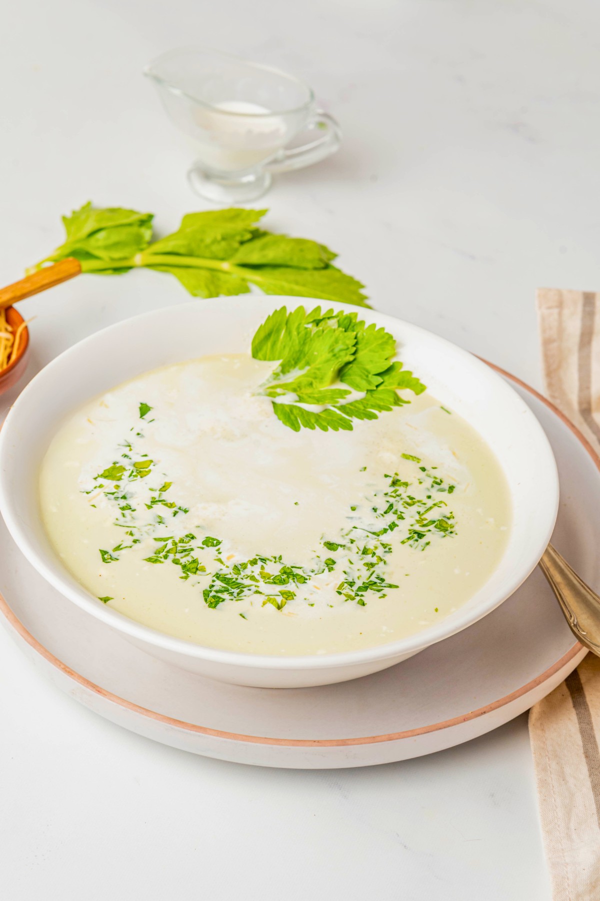 a bowl of celery soup with heavy cream