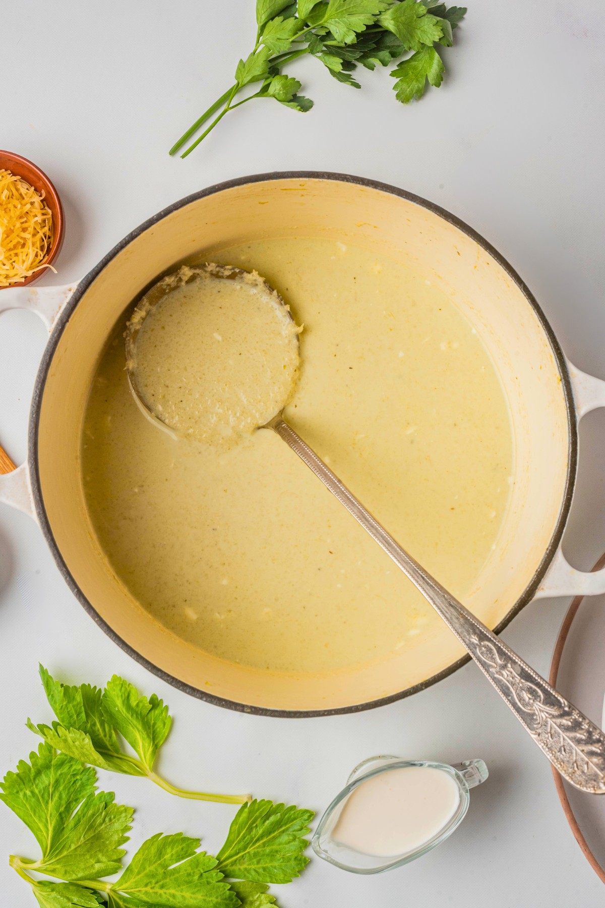 using a ladle for the cream of celery soup