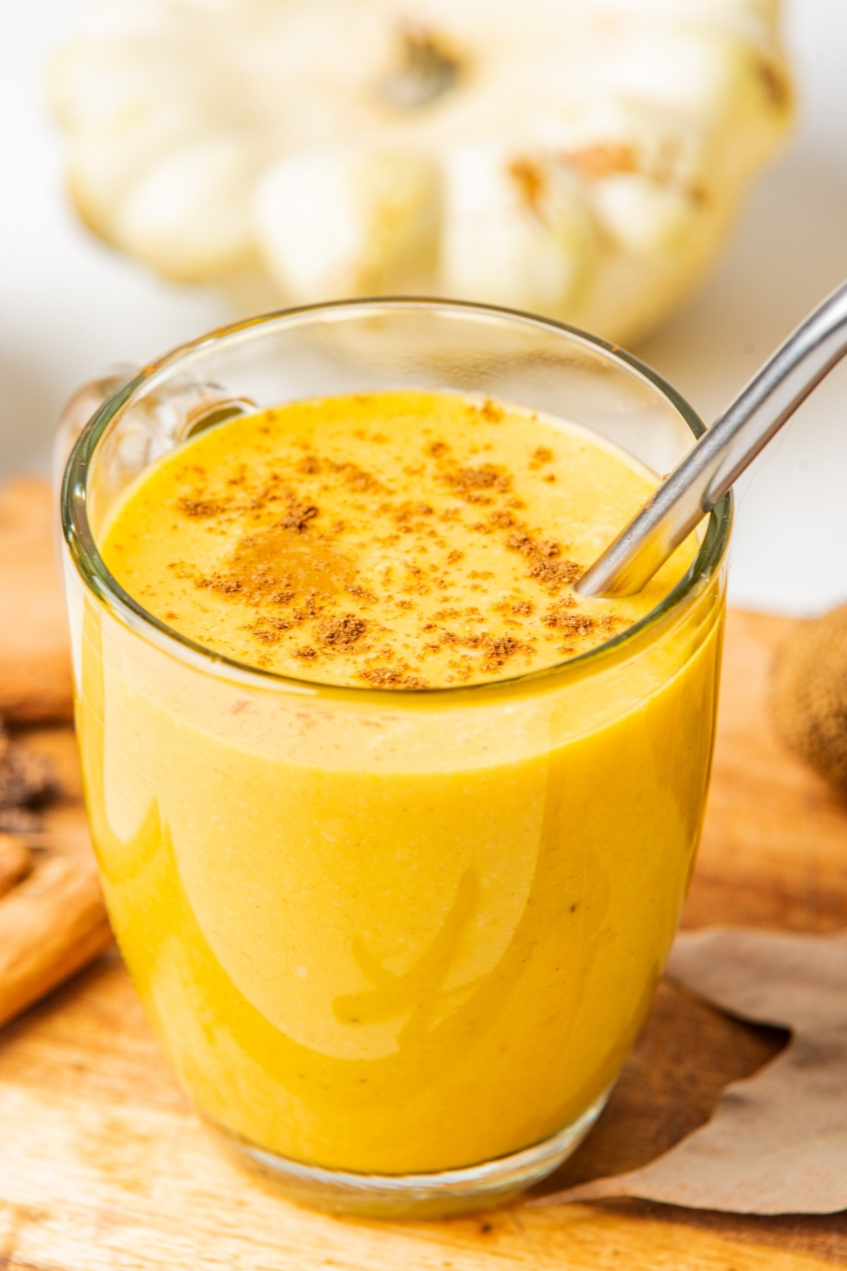 adding pumpkin pie spice over the top of smoothie. 