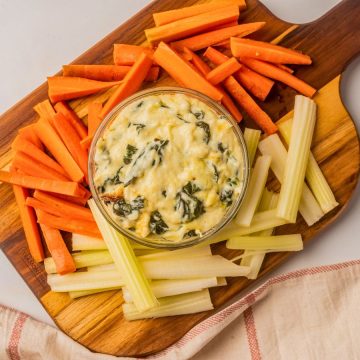 overhead hot spinach dip with carrots and celery.