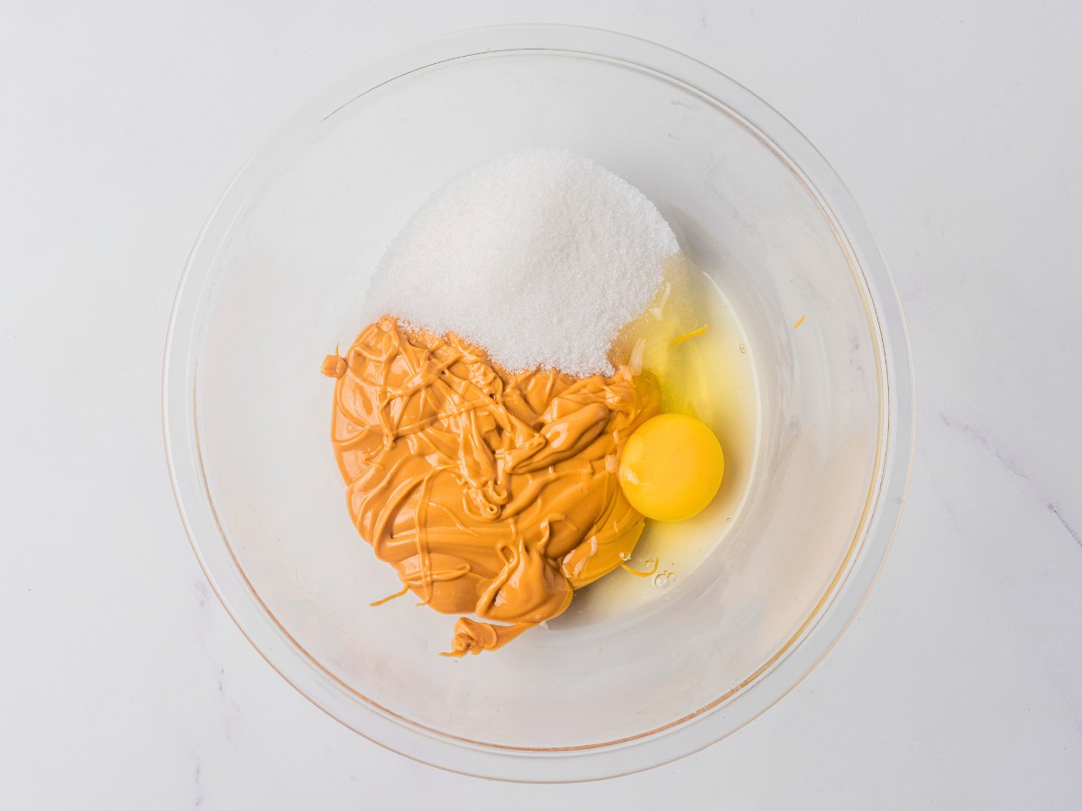 all peanut butter cookie ingredients in a glass bowl. 