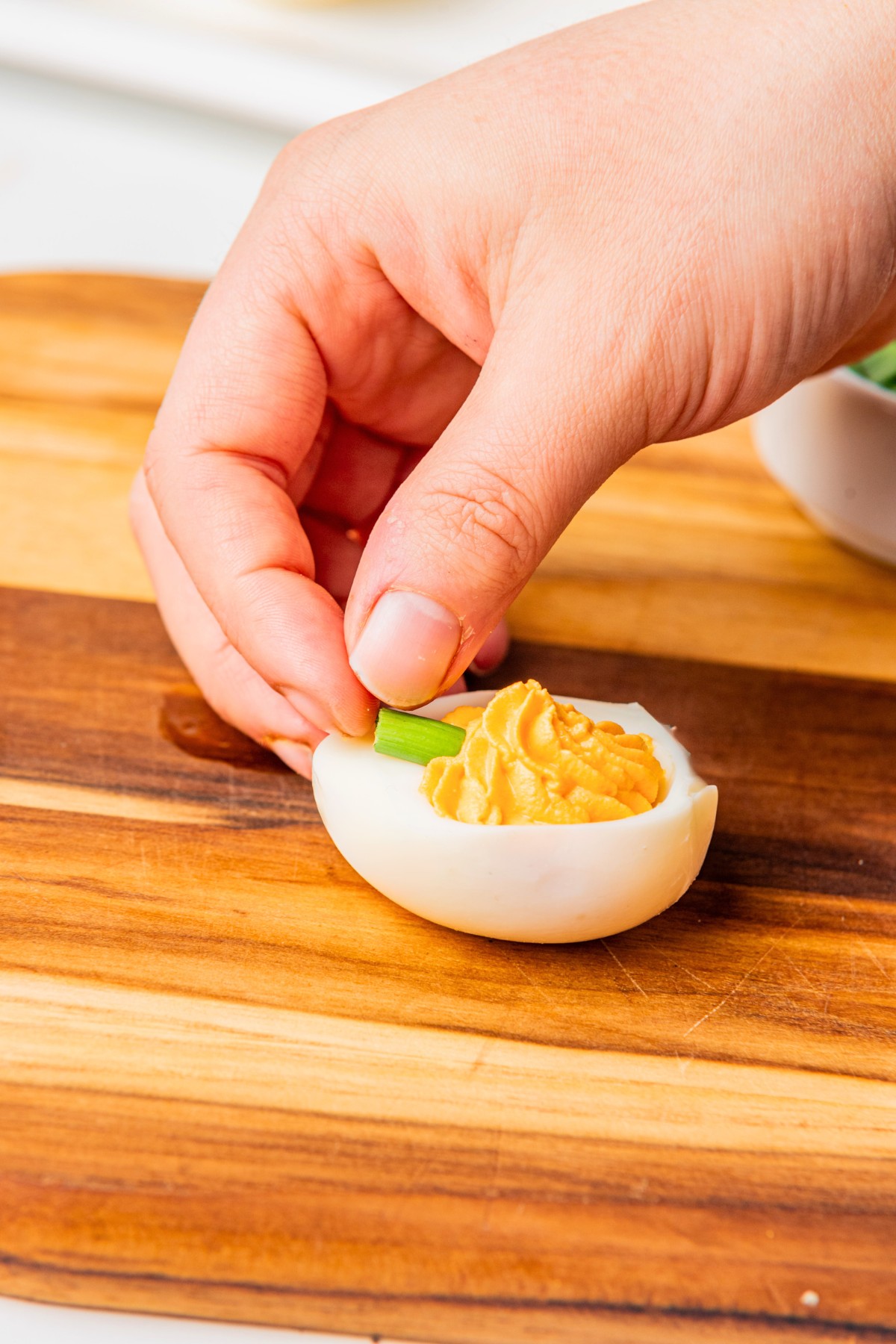 adding green onion scallion to deviled egg. 