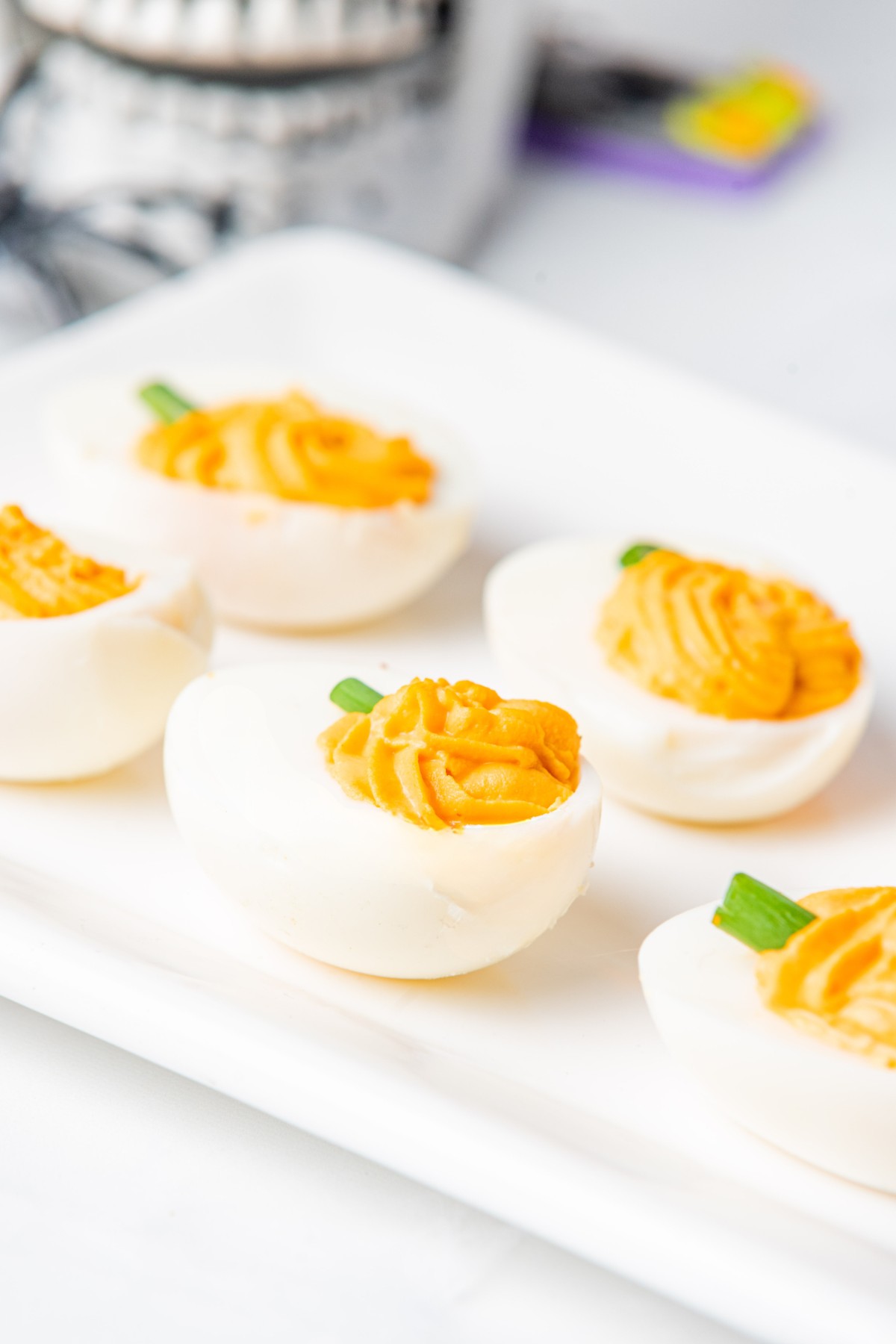 side shot of pumpkin deviled eggs. 