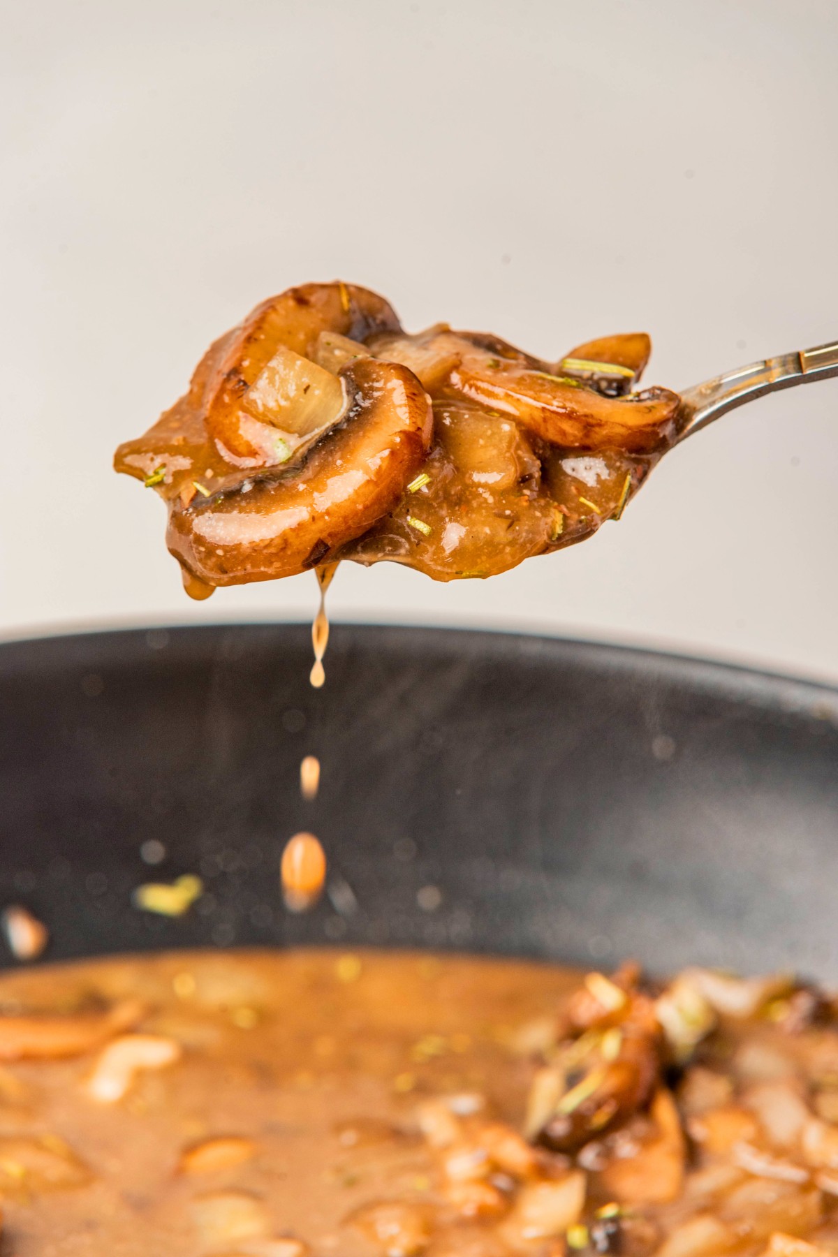 pouring a spoon of mushroom gravy