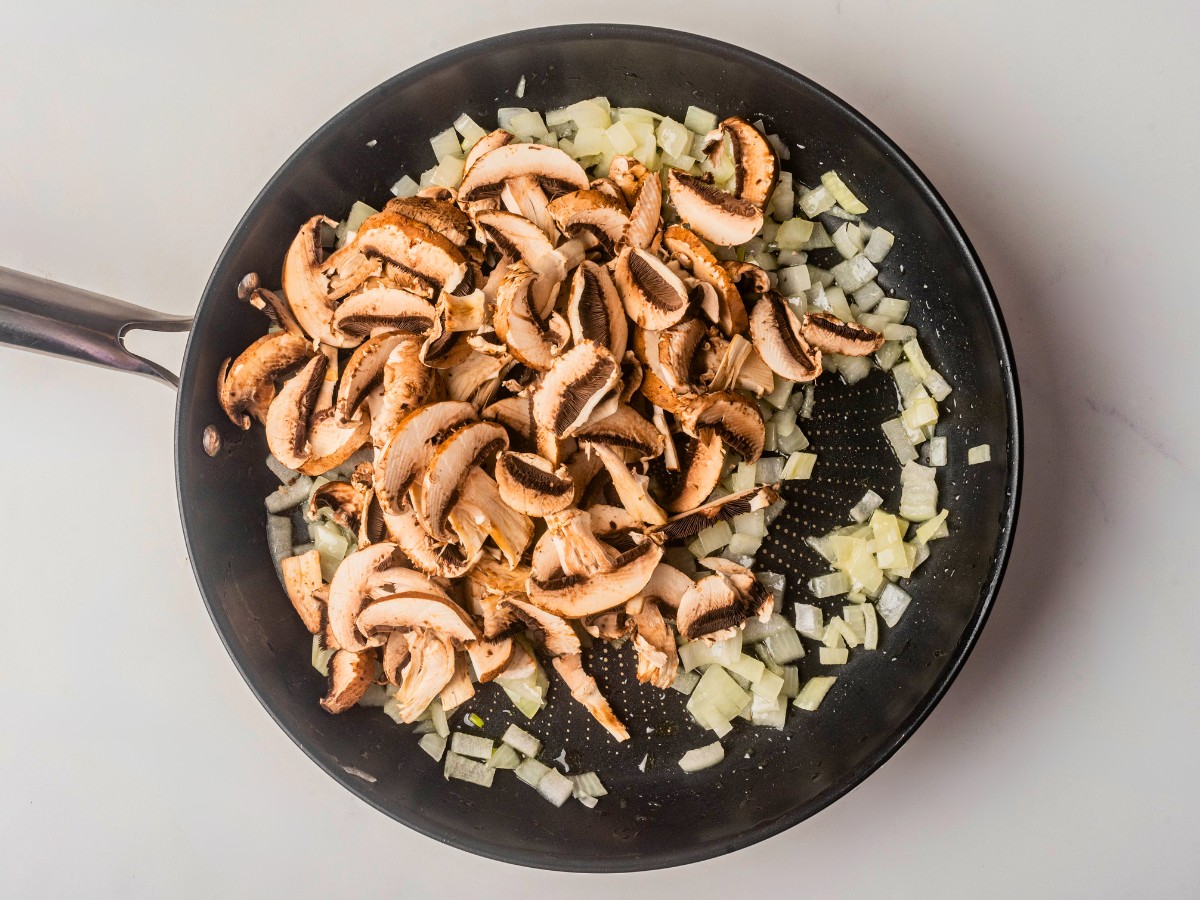 adding sliced mushrooms with sauteed onions