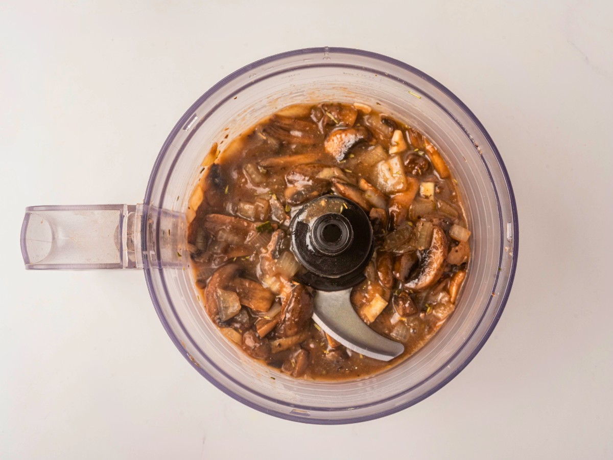 adding cooked mushrooms to food processor