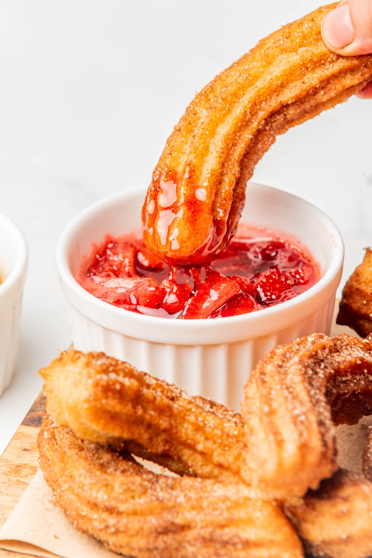 keto cinnamon churro dipped in strawberry topping