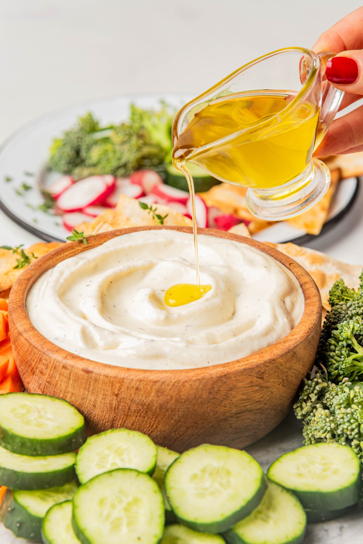 drizzling olive oil over the top of ricotta dip