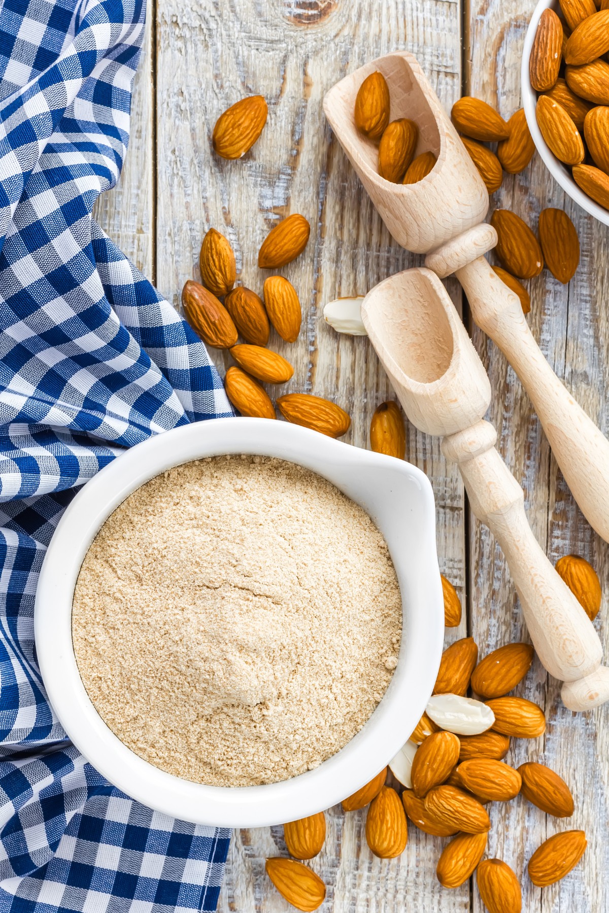 almond flour in a white bowl with raw almonds 