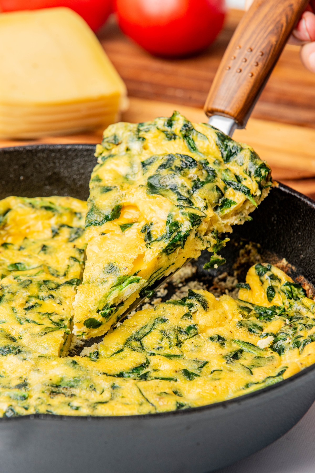 cutting a slice of egg frittata to serve.