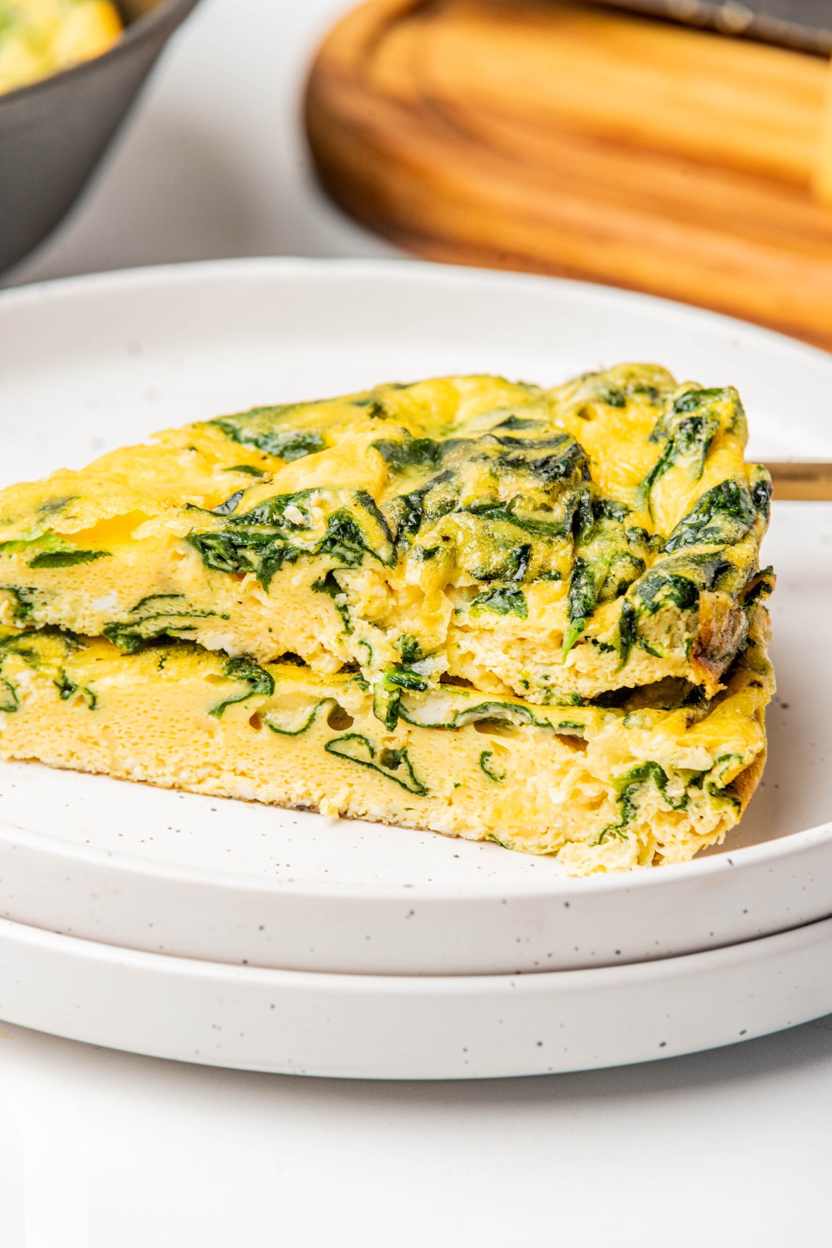 side ways view of two slices of spinach frittata. 