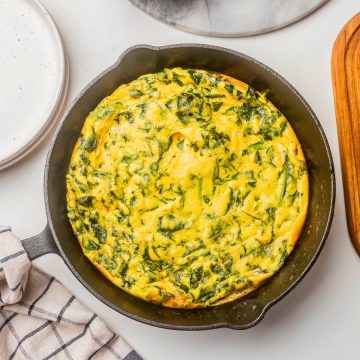 goat cheese spinach frittata in a hot skillet pan.