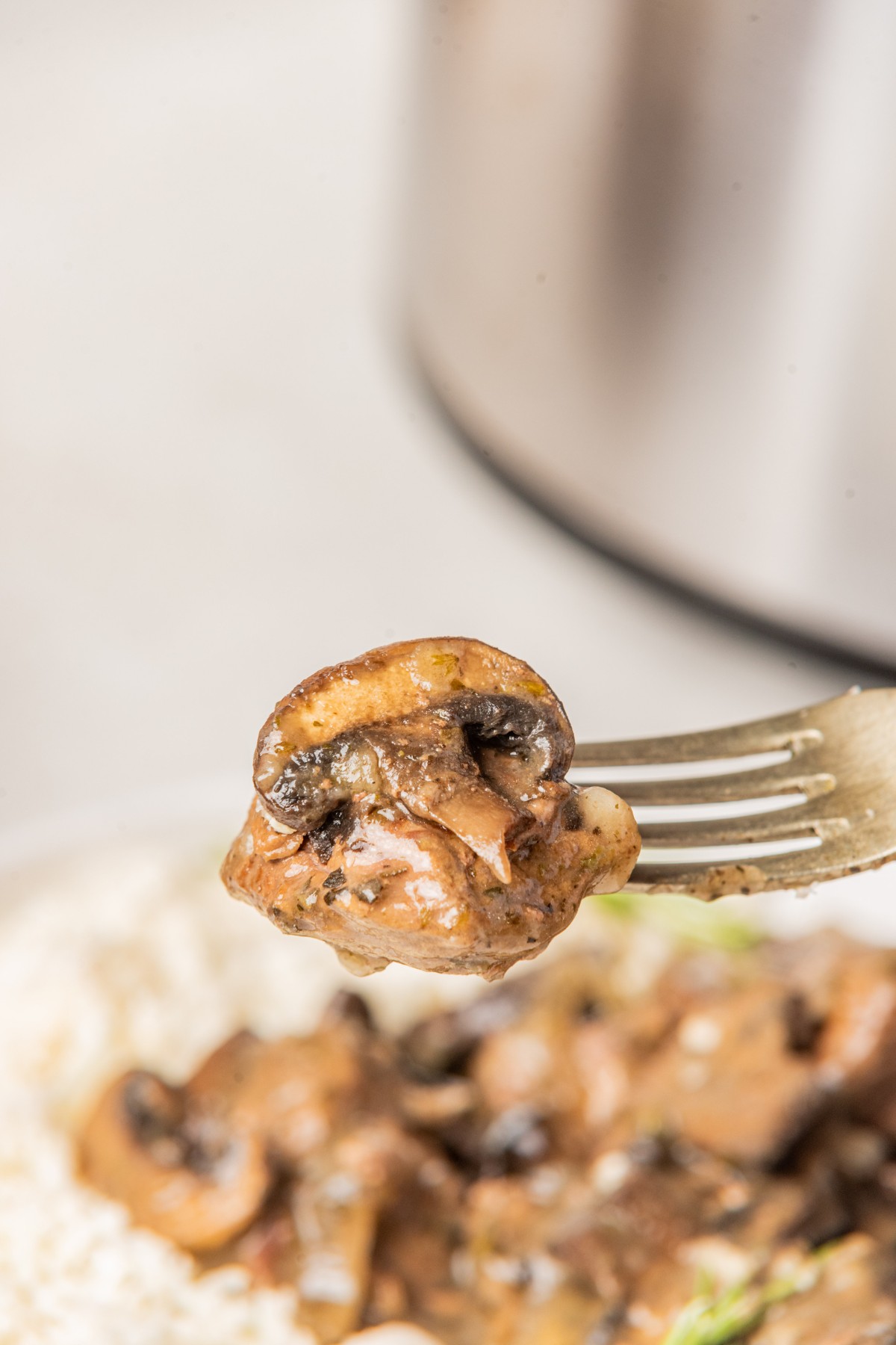 bite of beef with mushroom on a fork