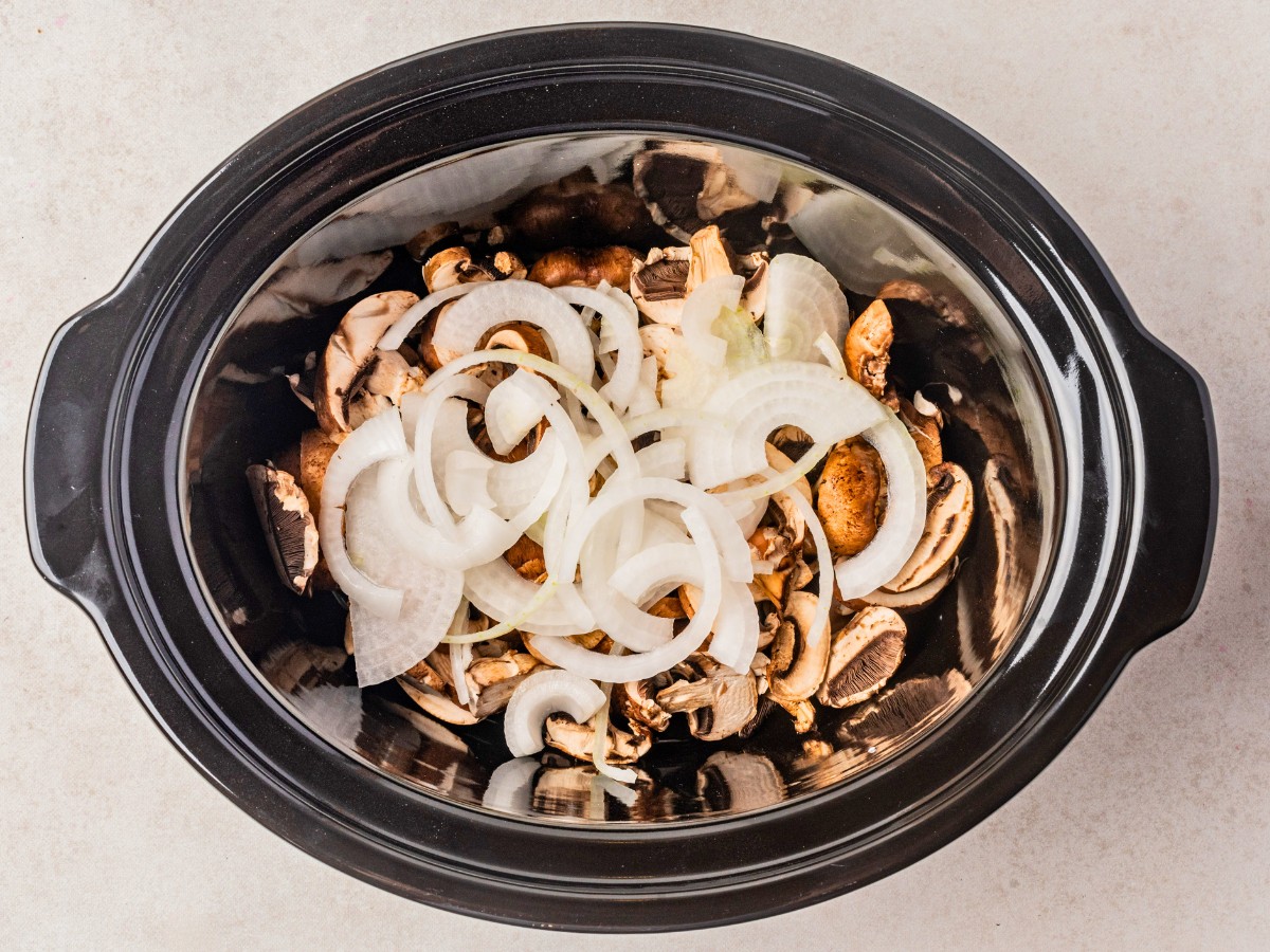 sliced onions and mushrooms added to crockpot