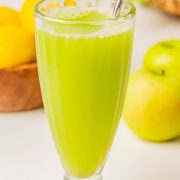 a glass full of celery and apple smoothie