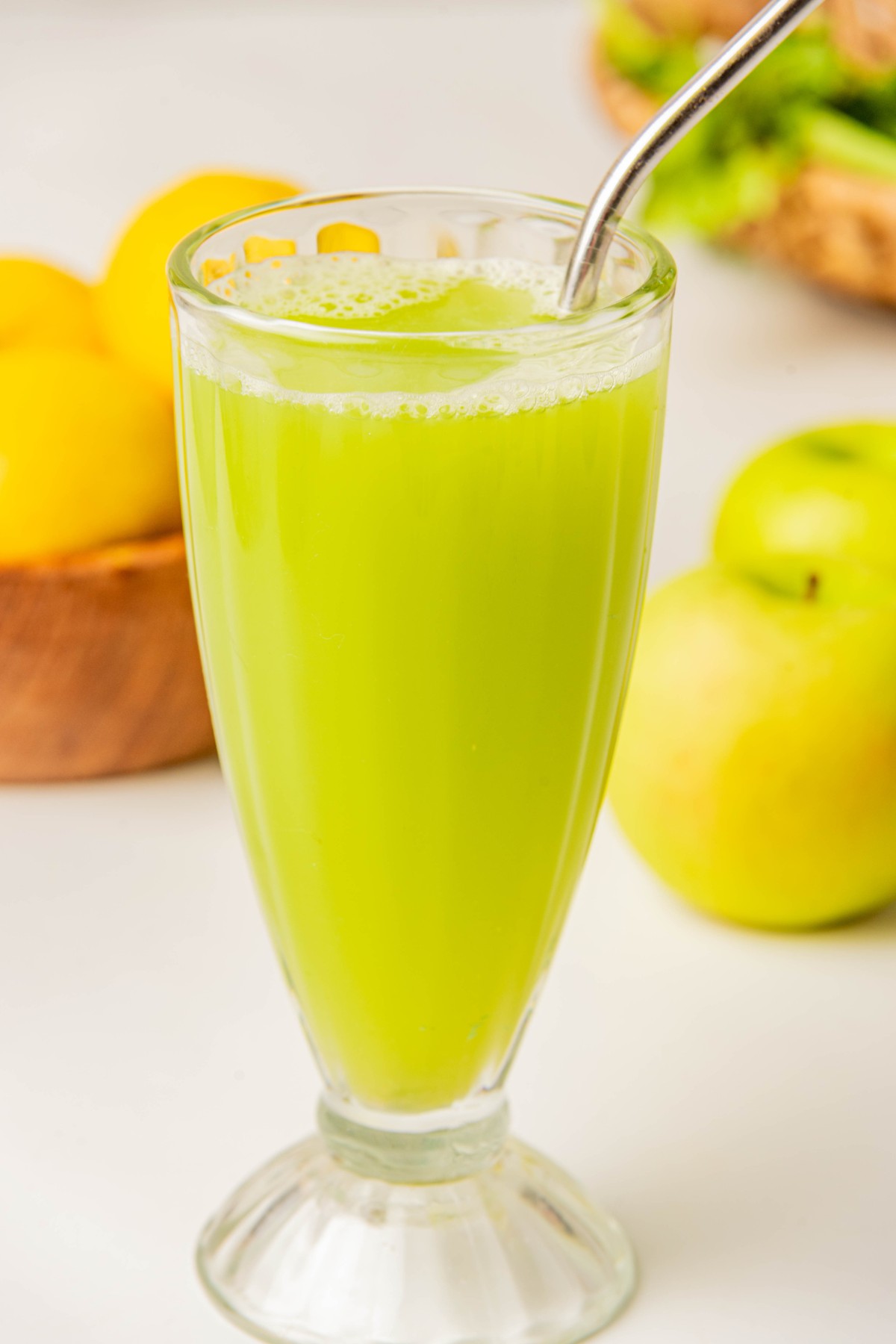a glass full of celery and apple smoothie