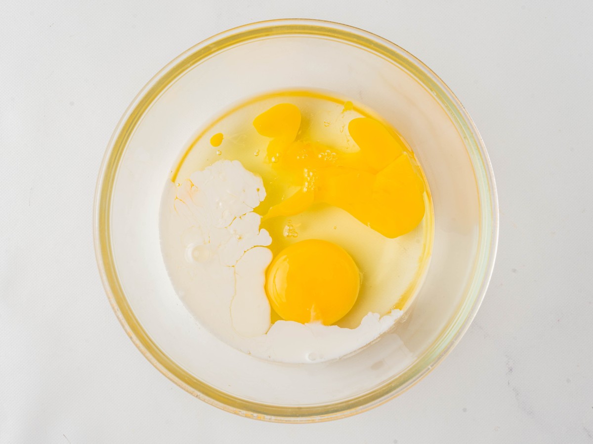 heavy cream and eggs in a glass bowl before mixing.