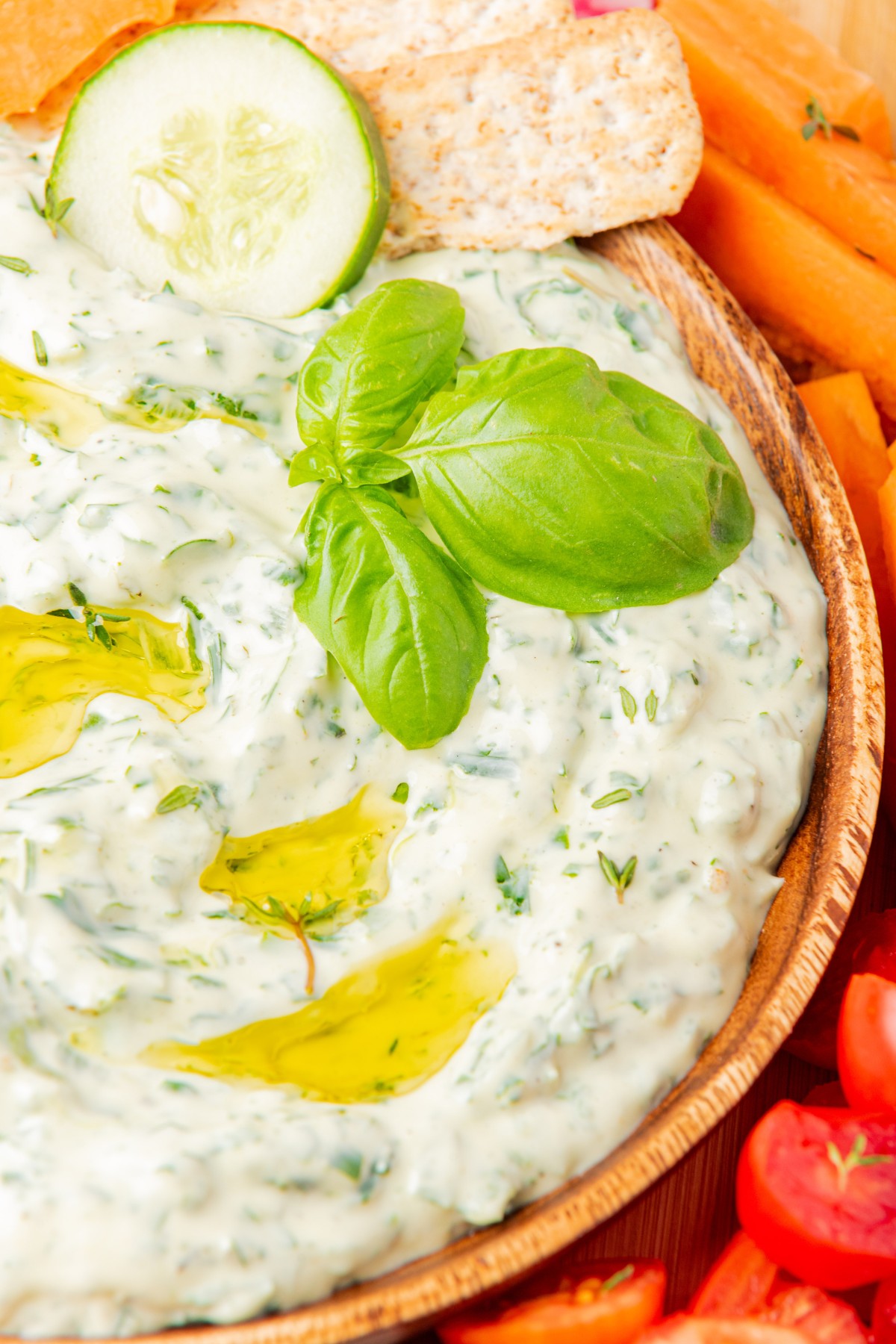 close up of green goddess dip with fresh basil and olive oil 