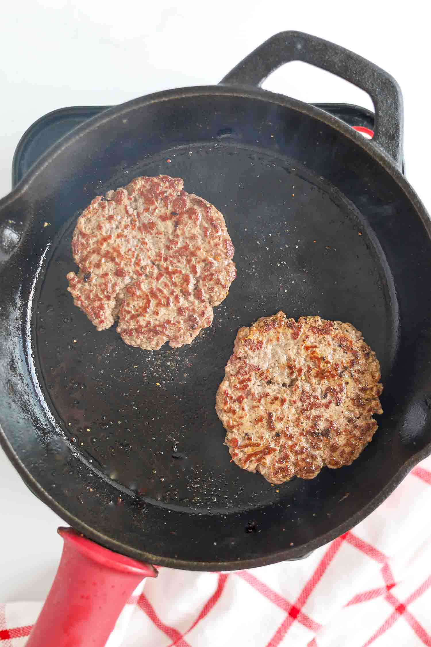 grilled burger patties on hot skillet pan 