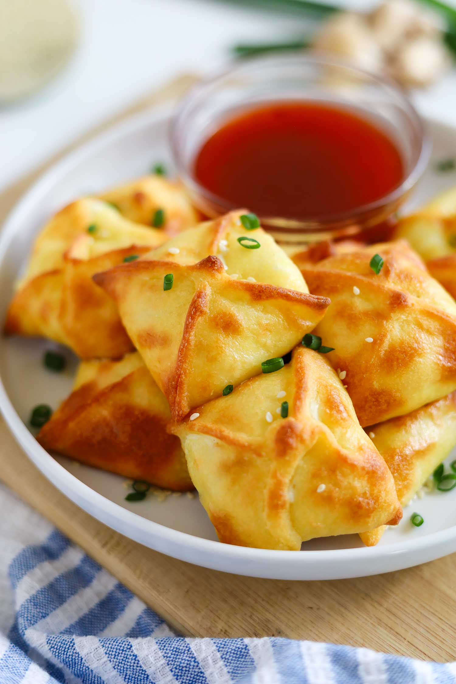 stacked crab rangoons on a white plate
