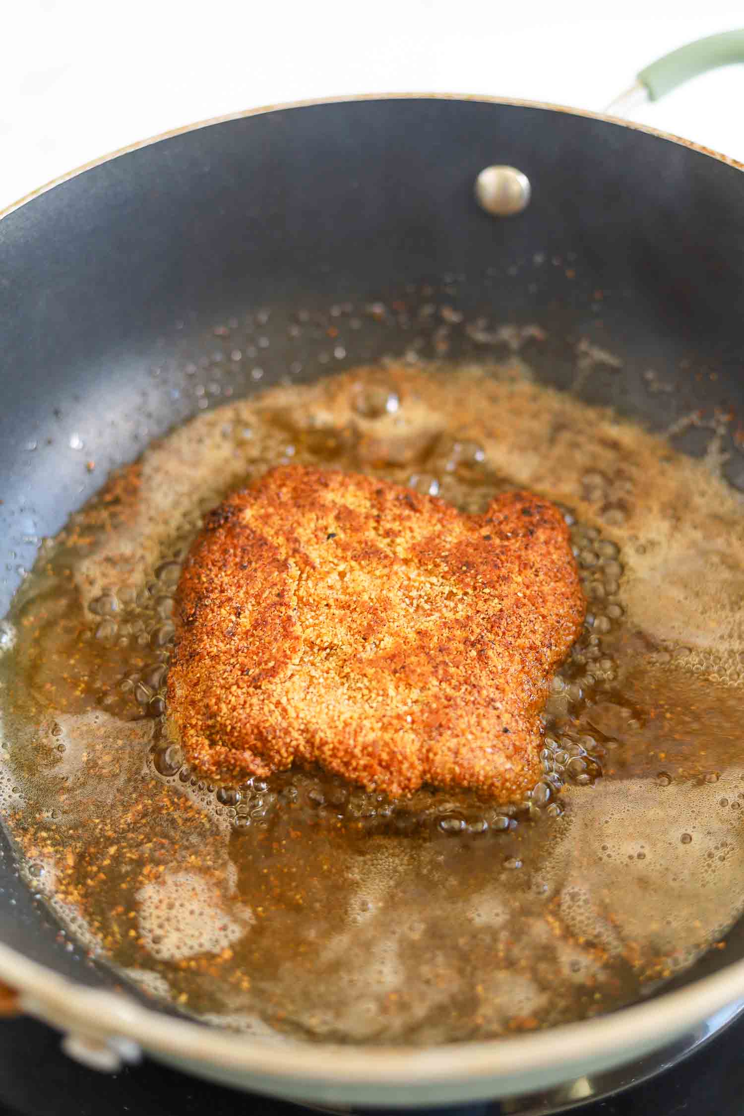 frying chicken fried steak in pan with oil 