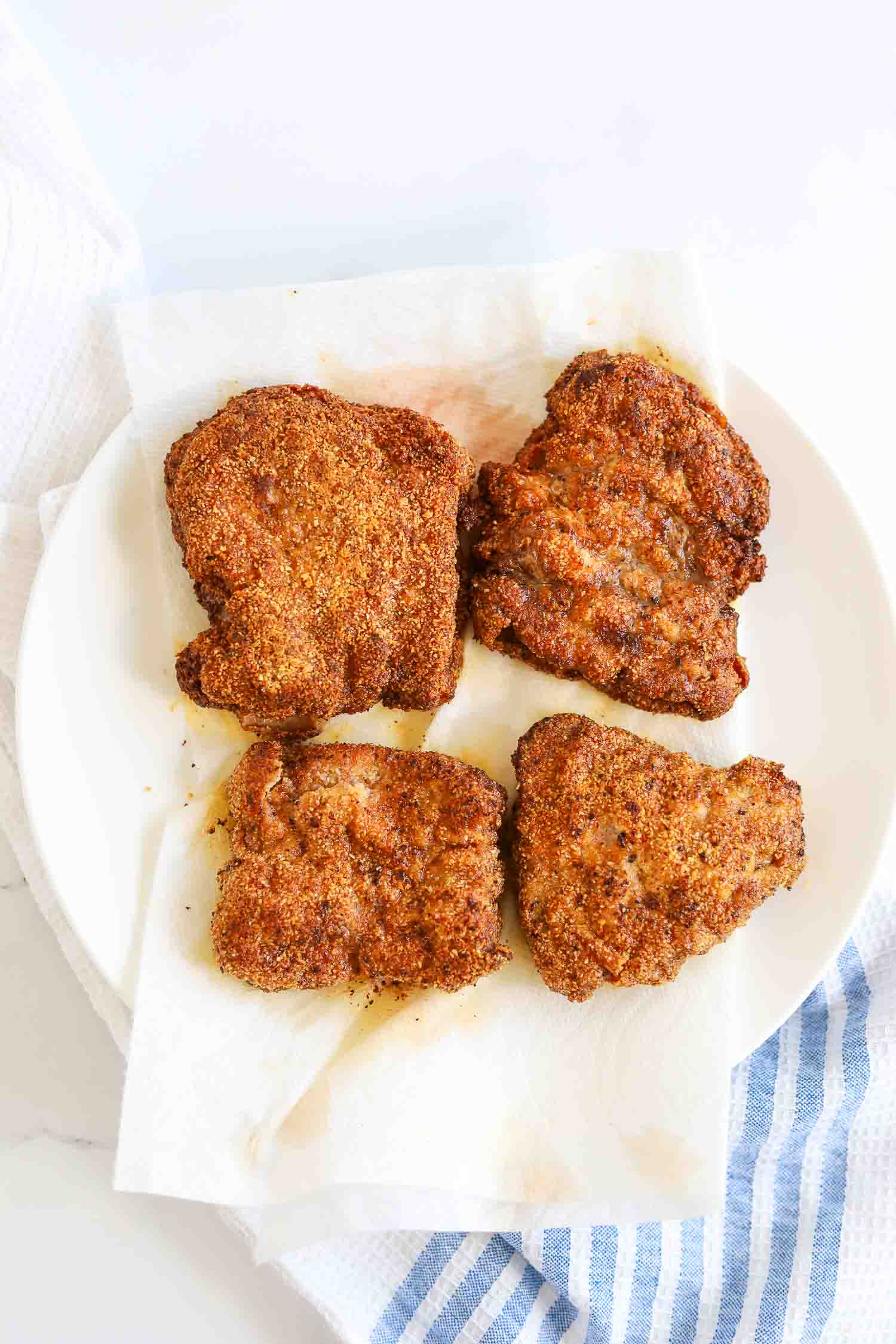 low carb chicken fried steak on a plate with white paper towel 