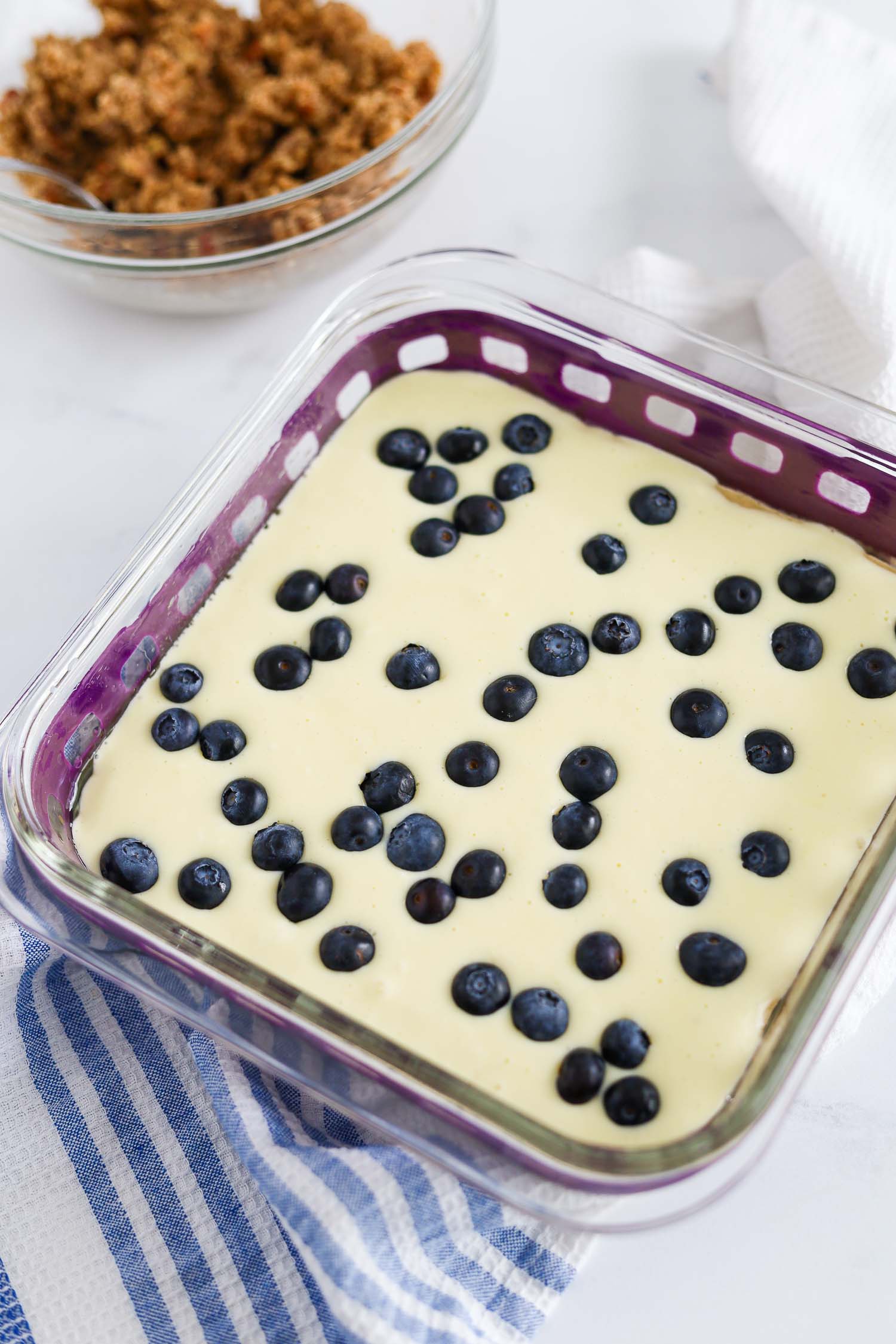 adding blueberries to the cheesecake layer 