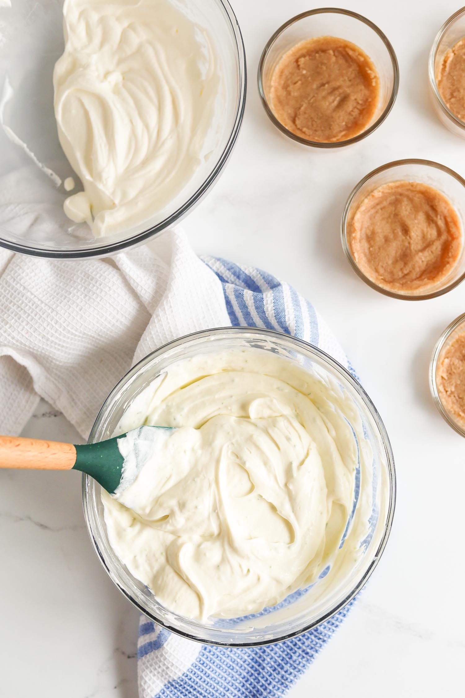 mixing together homemade whipped cream with key lime cheesecake filling 